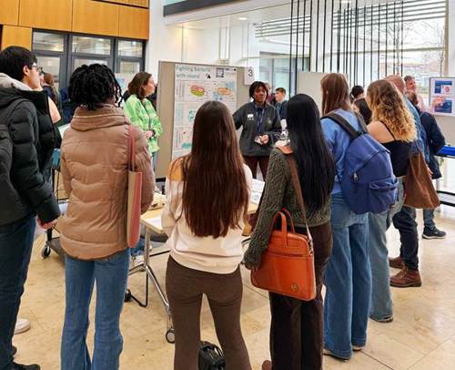 A group of people standing in a room

AI-generated content may be incorrect.
